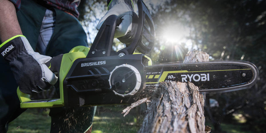 Gritty image of a Ryobi brushless chainsaw cutting through tree