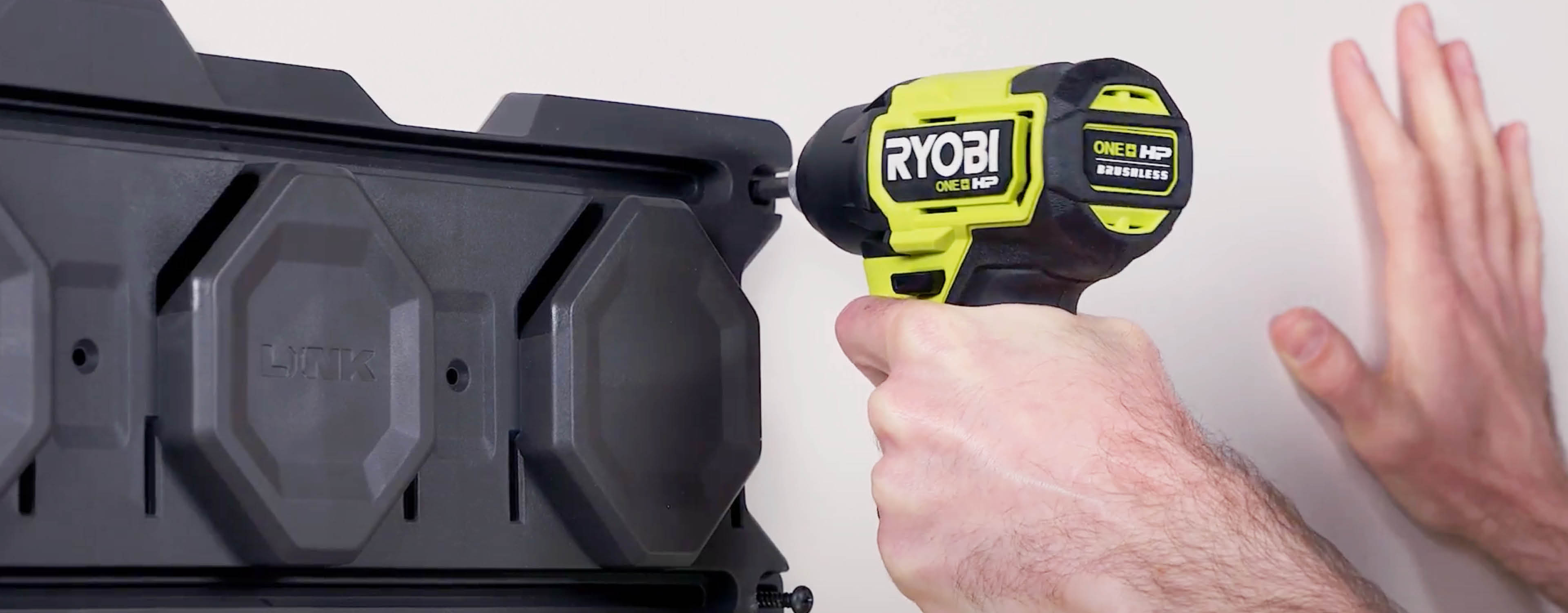 Ryobi LINK rail being installed on a white wall