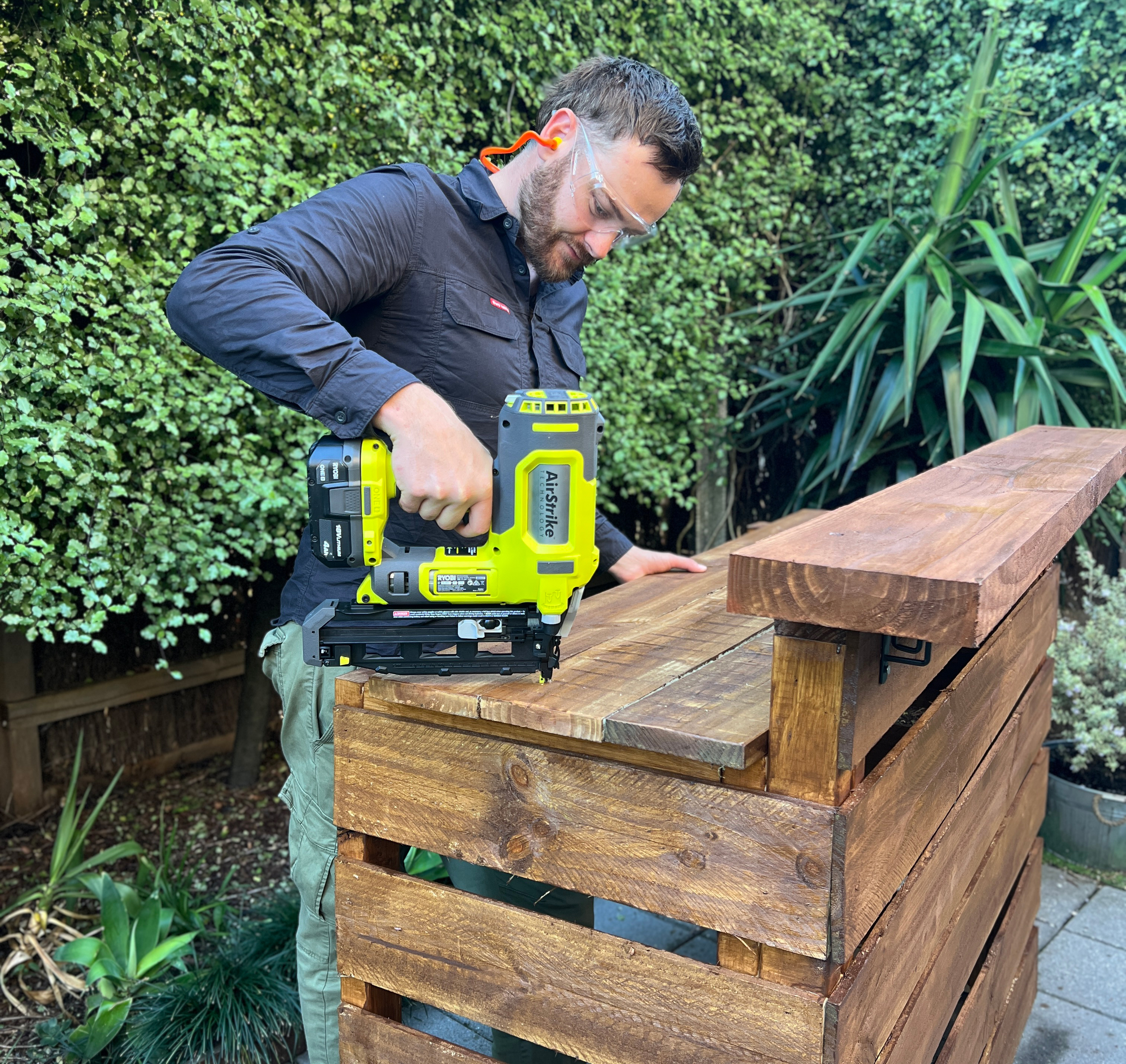 Finishing a DIY backyard bar using a RYOBI Brad Nailer